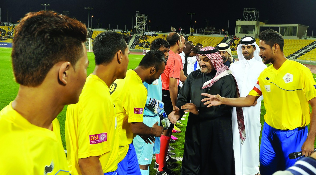 Qatar Stars League (QSL) CEO Hani Ballan and Nasser AlKhater, Executive Director of Communications and Marketing at Supreme Committee for Delivery & Legacy (SC), are introduced to the players during the inauguration of the Workers Cup at Qatar SC Stadium 