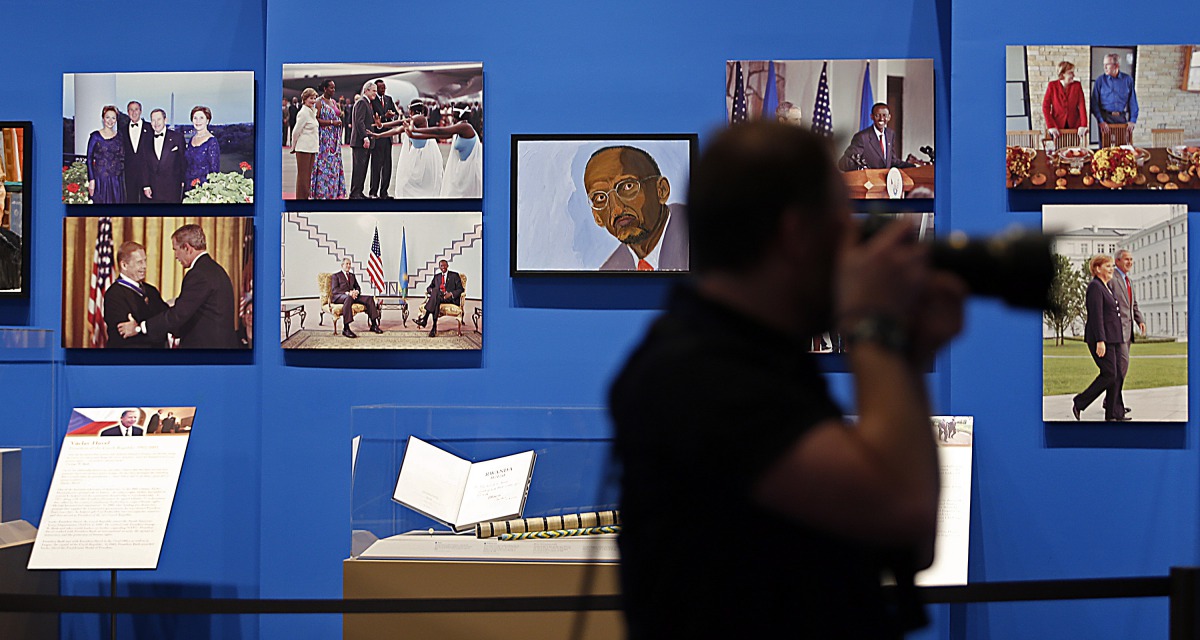 This file photo taken on April 3, 2014 shows paintings by former US President George W. Bush on display with photographs as part of the exhibit, 