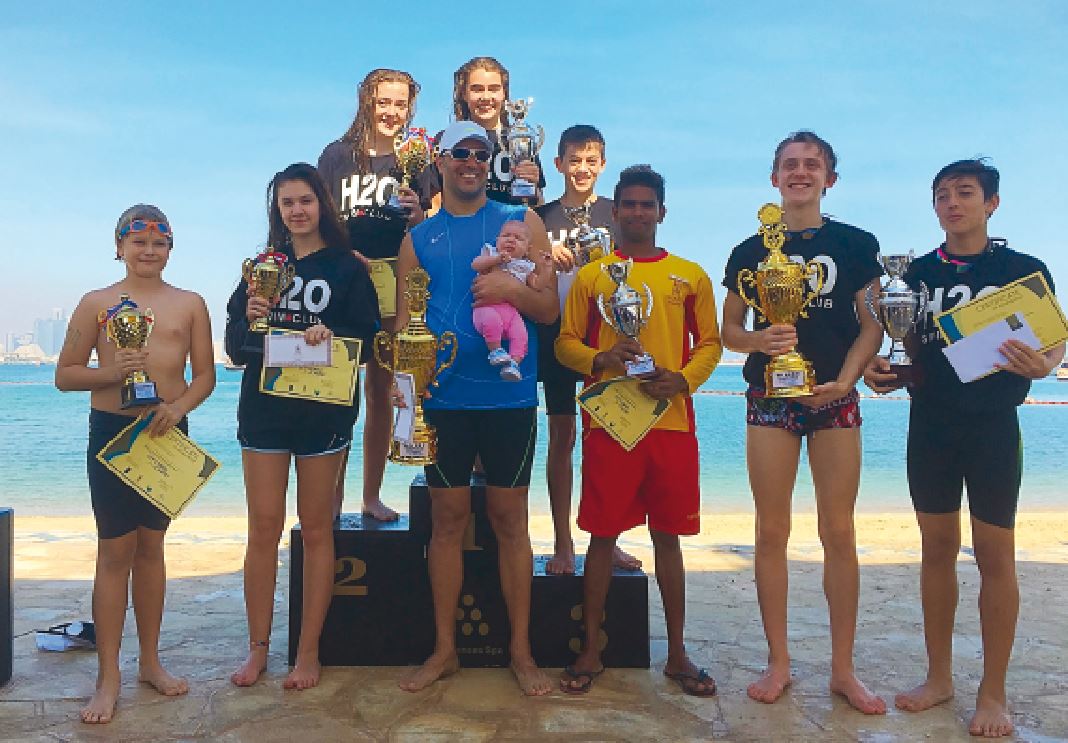 The winners of last year's Sharq Village and Spa - Swimming Challenge pose for a photograph with trophies in this file photo.