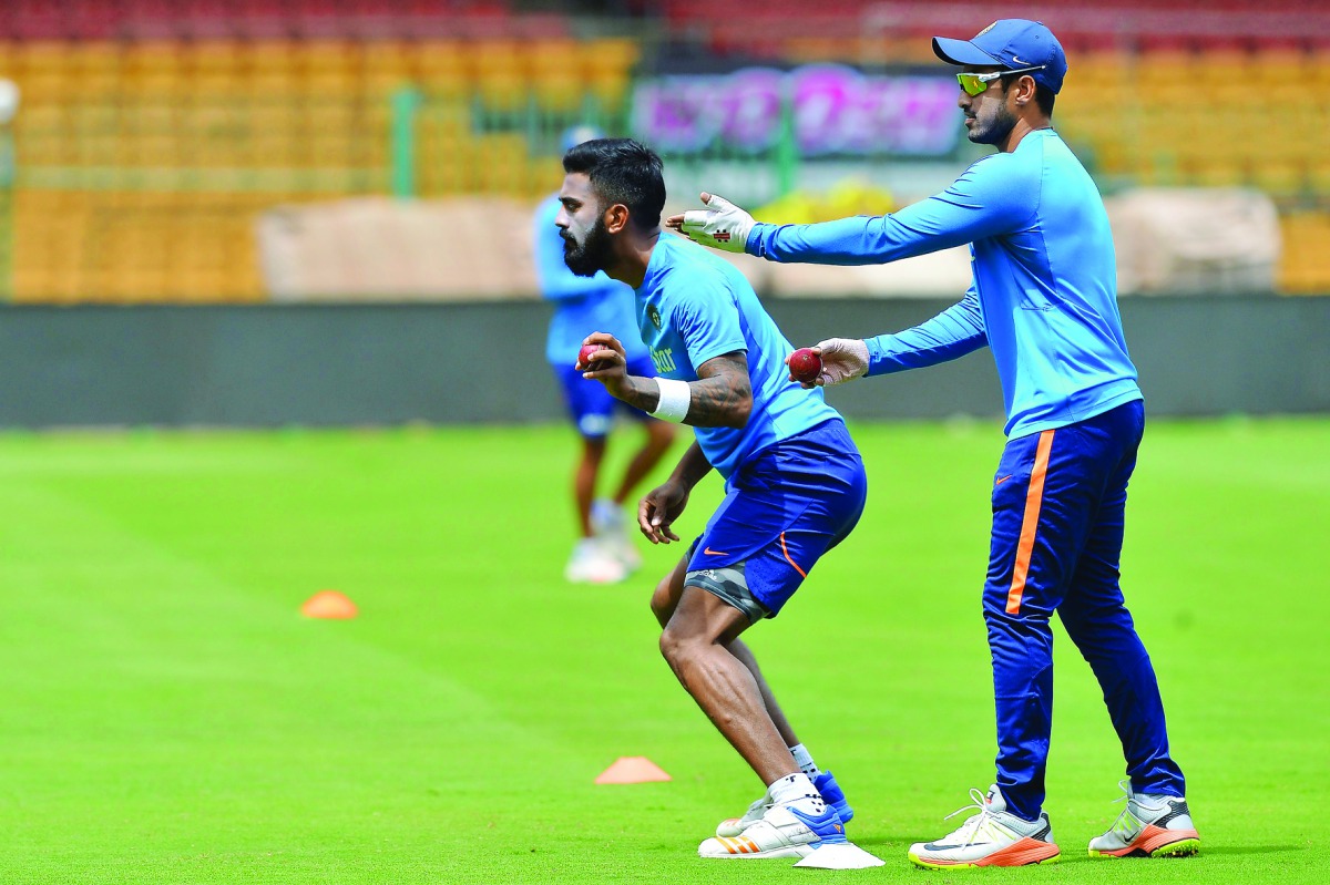 Indian cricketers KL Rahul (left) and Karun Nair stretch during a practice session prior to the second Test against Australia at the M Chinnaswamy Stadium in Bangalore yesterday.