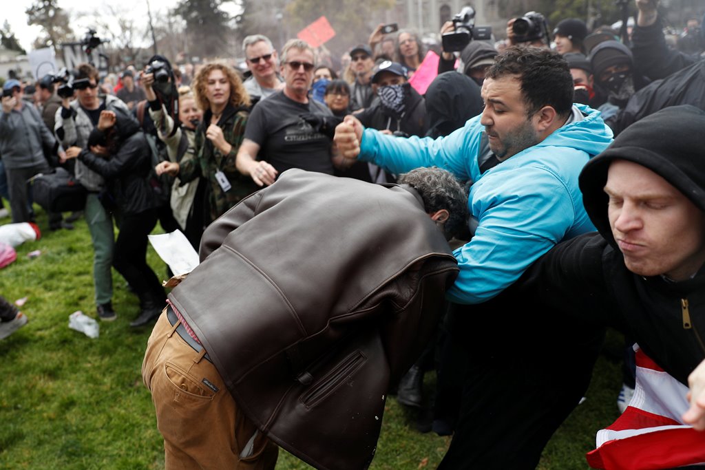 A demonstrator in support of U.S. President Donald Trump (L) scuffles with a counter-protester during a 