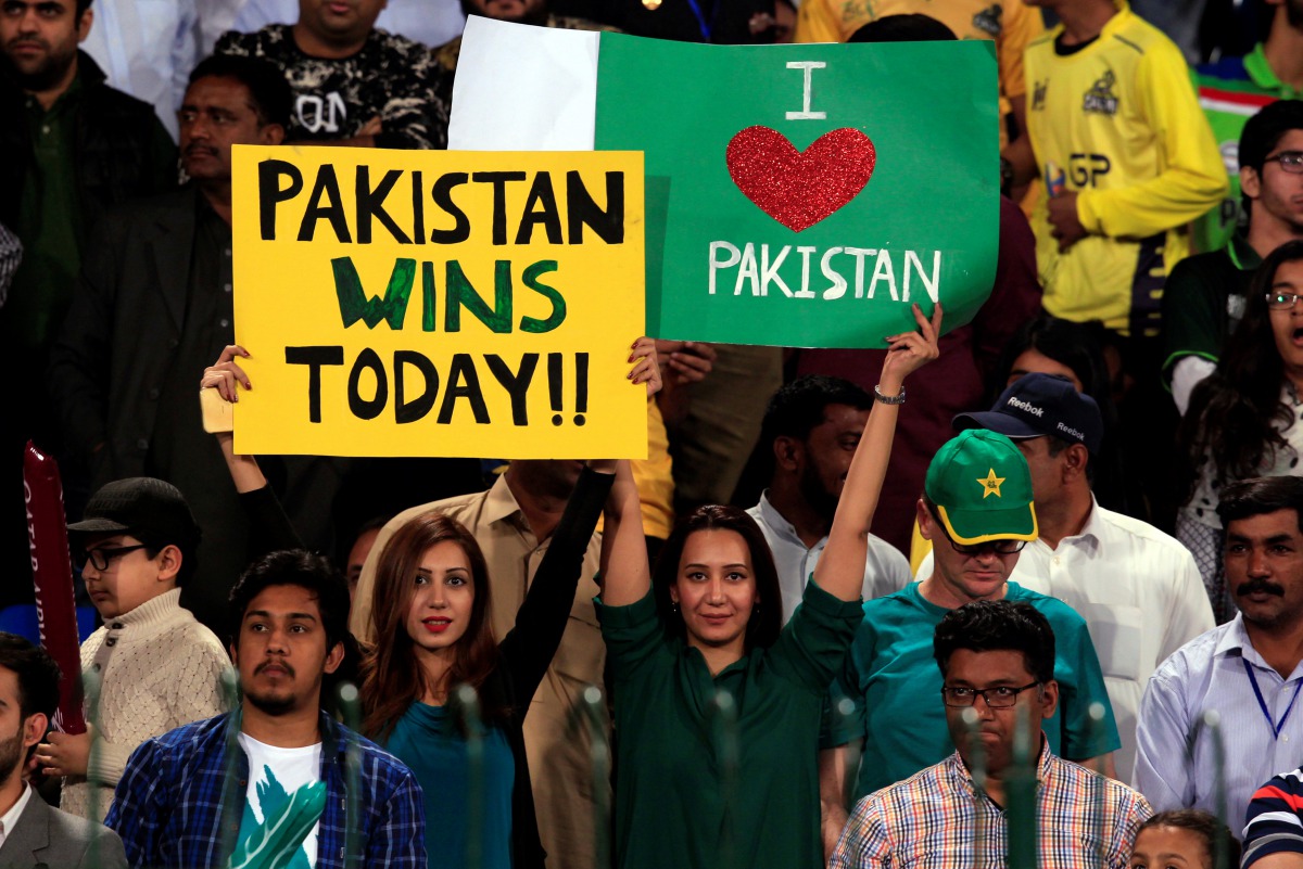 Pakistani spectators hold placards at Gaddafi Cricket Stadium as they wait for the start of a hugely anticipated finals of its domestic cricket league, Pakistan Super League (PSL) in Lahore, Pakistan, March 5, 2017. (REUTERS/Faisal Mahmood)