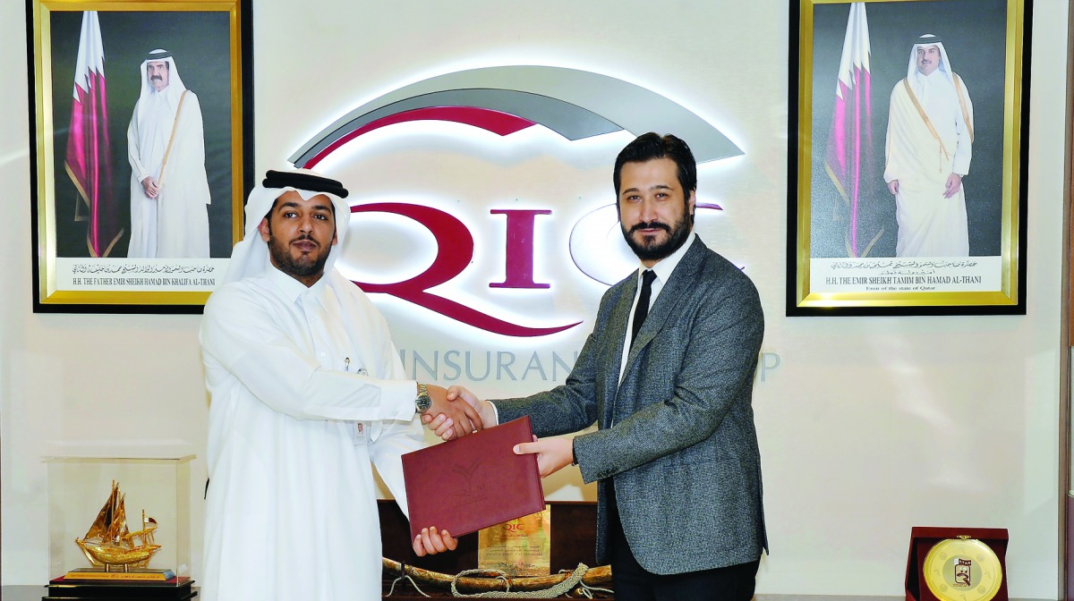 Salem Al Mannai (left) and Dr Volkan Uygunucarlar exchanging documents after signing the agreement.  Pic: Kammutty VP / The Peninsula