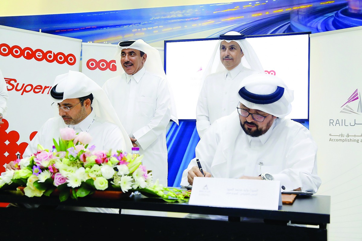 Officials of Ooredoo and Qatar Rail signing the agreement.