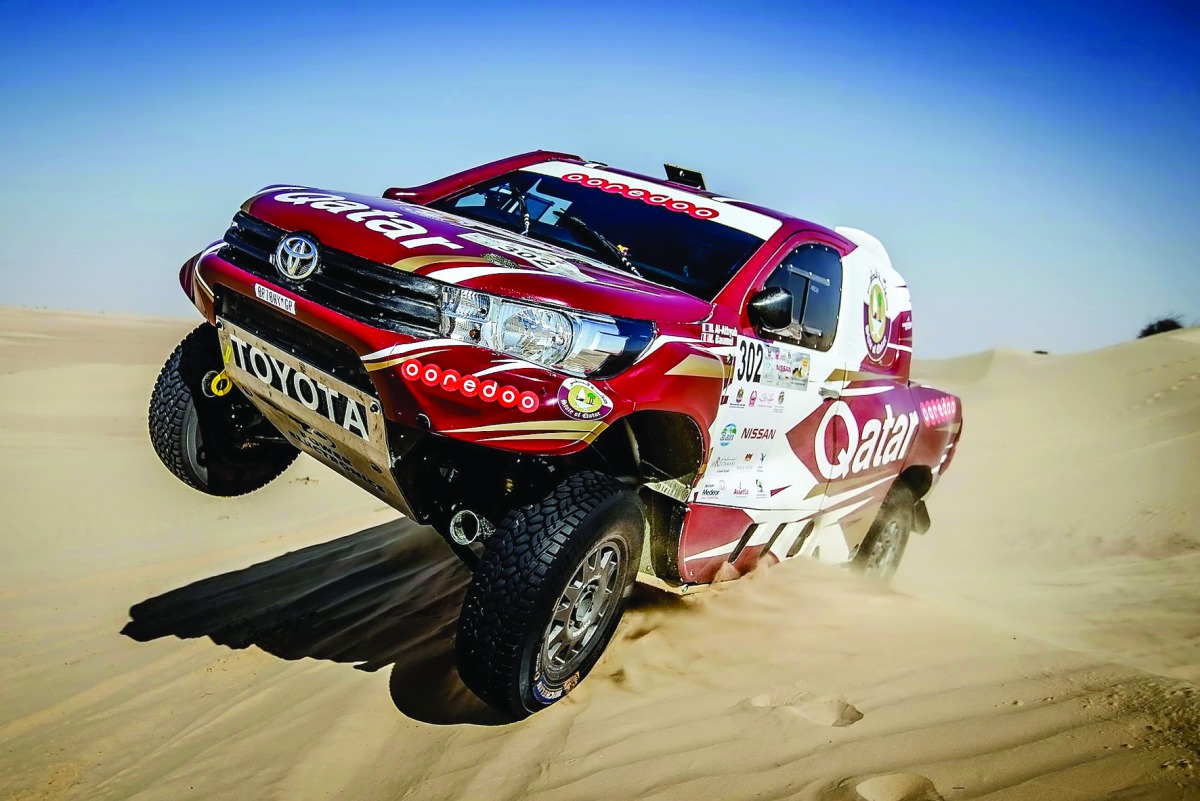 Qatari driver Adel Abdulla of Nissan drives over a sand dune in the Al Qudra desert during the Dubai International Baja.