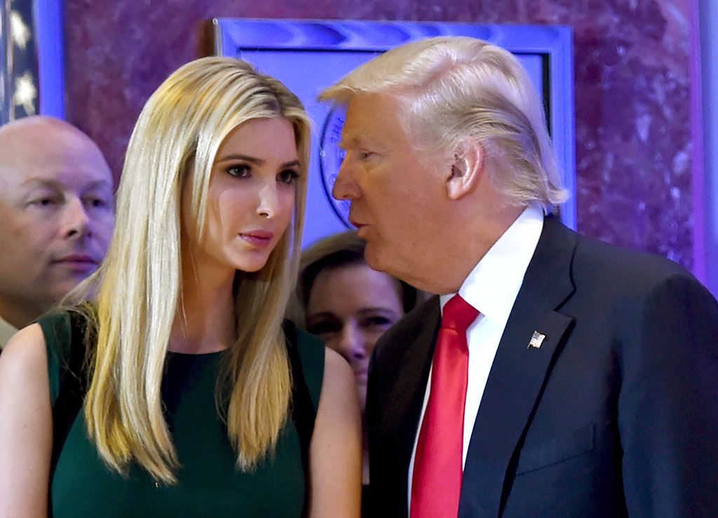 (FILES) This file photo taken on January 11, 2017 shows US President-elect Donald Trump talking to his daughter Ivanka during a press conference at Trump Tower in New York. AFP / Timothy A. Clary 