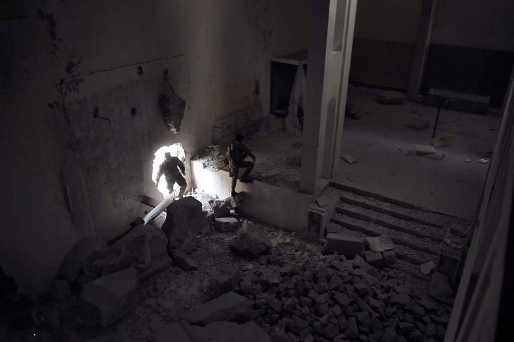 Members of the Iraqi forces enter the destroyed building of the museum of Mosul on March 11, 2017 after it was recaptured from Islamic State (IS) group fighters. Iraqi forces seized the building from IS on March 7 as they pushed into west Mosul as part of