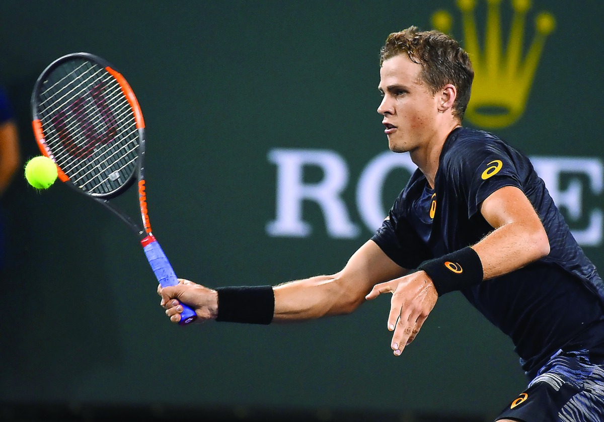 Vasek Pospisil of Canada returns the ball to Andy Murray of Great Britain in their second round match at the BNP Paribas Open at the Indian Wells Tennis Garden. Pospisil won 6-4, 7-6.