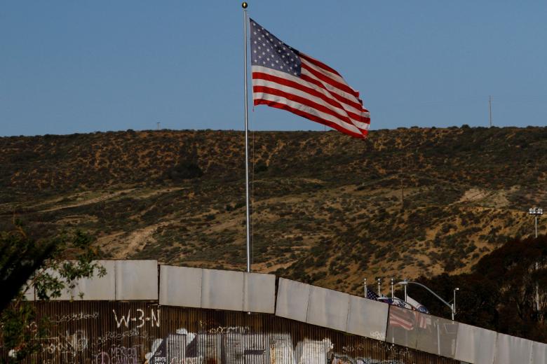 A US flag seen next to a section of the wall separating Mexico and the United States, in Tijuana, Mexico. Reuters/Jorge Duenes
