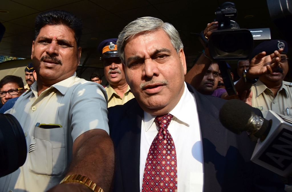 (FILES) This file photo taken on October 19, 2015 shows Shashank Manohar, the then-Board of Control for Cricket in India (BCCI) president and more recently the International Cricket Council (ICC) chairman, being escorted out of the Indian cricket board's 