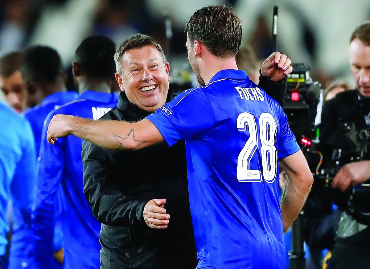 Leicester City manager Craig Shakespeare celebrates with Christian Fuchs after the UEFA Champions League Round of 16 Second Leg match against Sevilla at the King Power Stadium, Leicester, England on Tuesday.