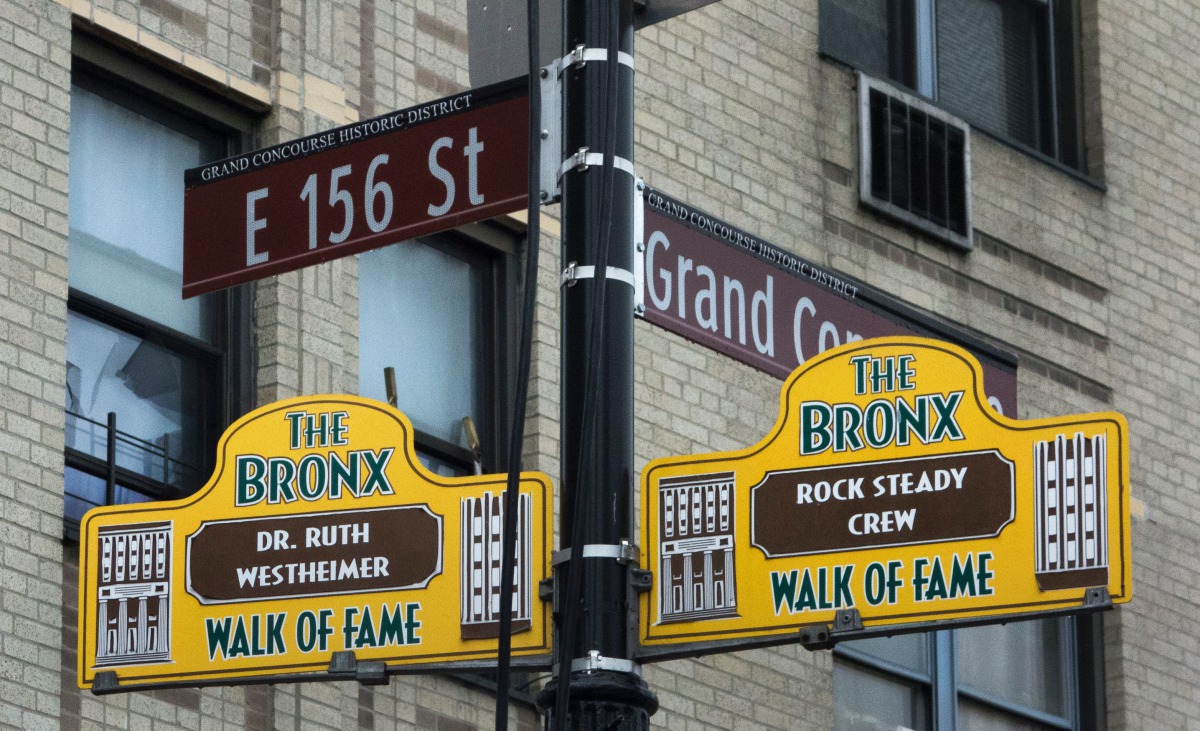Signs honoring Hip-Hop pioneers Rock Steady Crew and US therapist Dr Ruth Westheimer hang from a lamp post as part of the Bronx Walk of Fame in the Bronx on March 7 2017 in New York. AFP / Don Emmert
