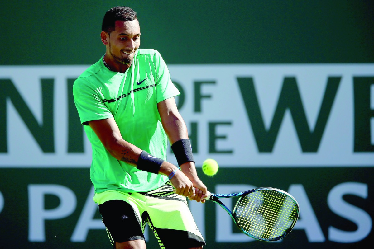 Nick Kyrgios of Australia returns a shot to Novak Djokovic of Serbia during the BNP Paribas Open at the Indian Wells Tennis Garden on Wednesday in Indian Wells, California. 
