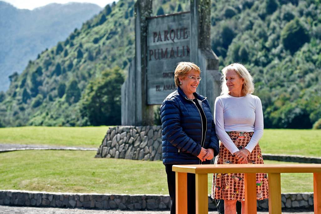 This handout photo released by the Chilean presidency shows President Michelle Bachelet (L) before signing a document to receive donation of 407,000 hectares of land from Kristine McDivitt (R) - the widow of U.S. conservationist and philanthropist Douglas