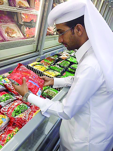 A Municipality official checking the expiry dates of products.