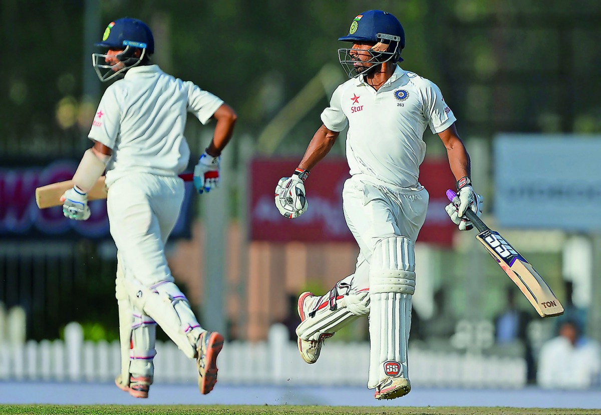 India's Wriddhiman Saha (right) and Cheteshwar Pujara run between the wickets during the third Test cricket match against Australia  at JSCA Stadium  Complex in Ranchi in this  March 18  file photo. 