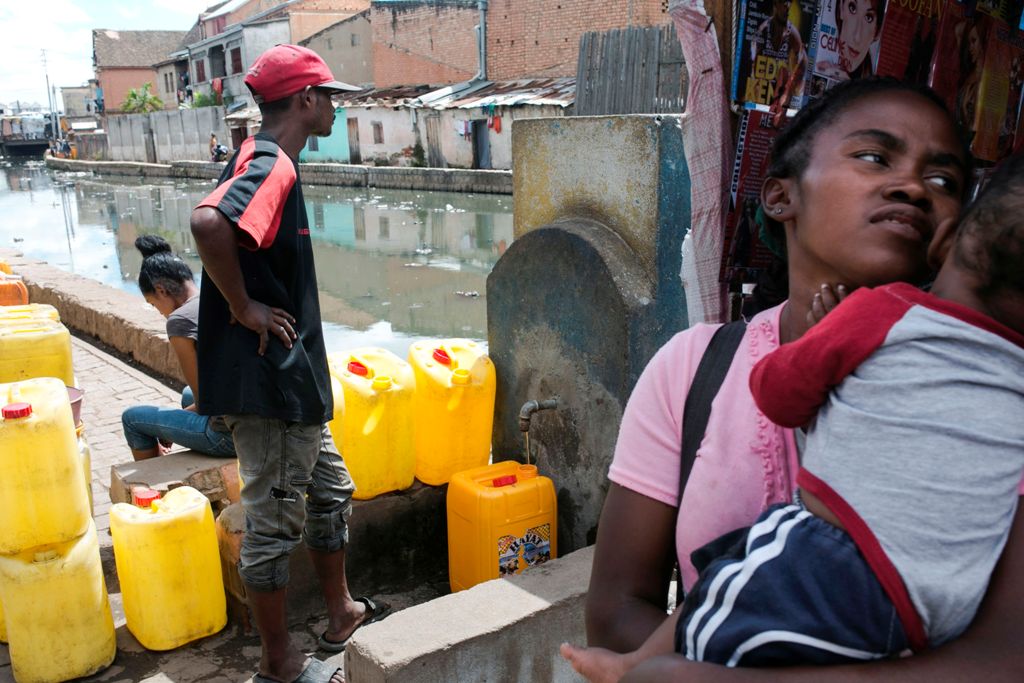 A man waits for his jerrycan to be filled at a public fountain during a period when the public water supply has been cut off, in the Isotry district of Antananarivo, Madagascar on March 17, 2017. 
/ AFP / RIJASOLO