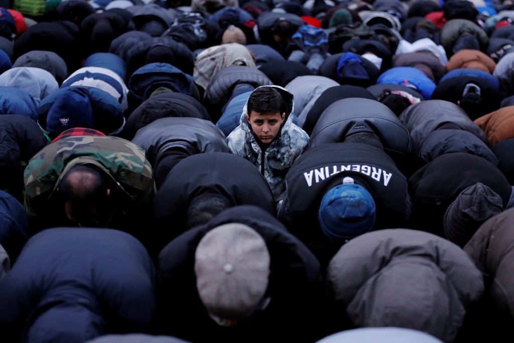 FILE PHOTO - A boy looks up as demonstrators pray while participating in a protest by the Yemeni community against U.S.  REUTERS/Lucas Jackson/File Photo
