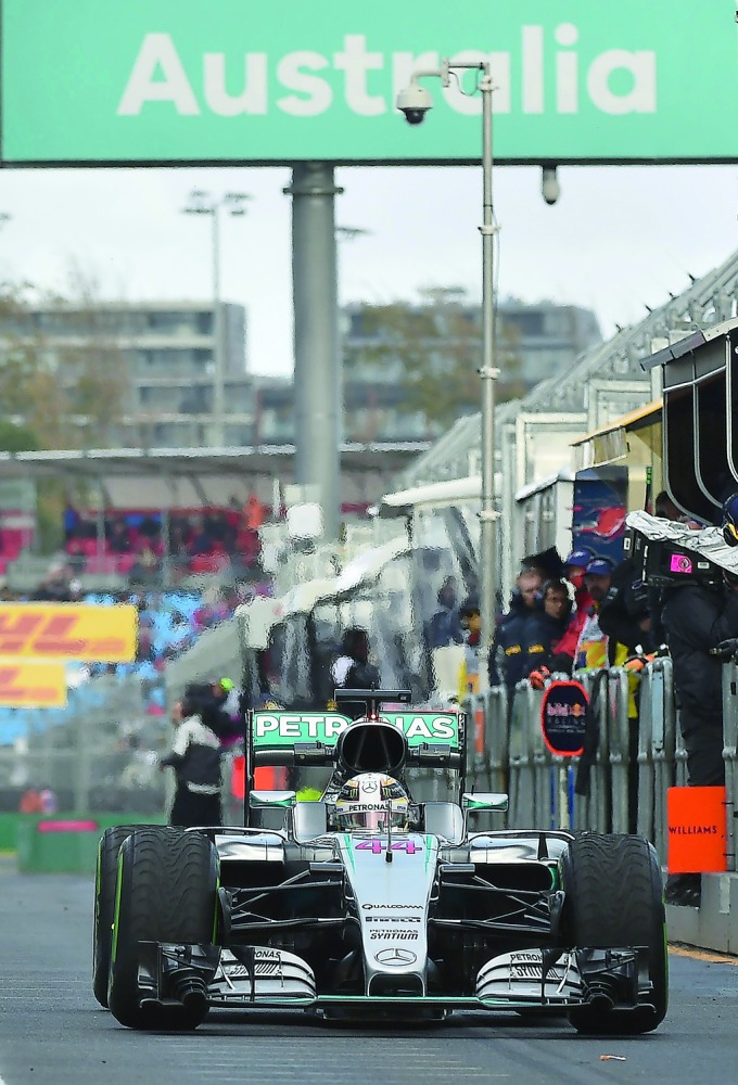 Mercedes British driver Lewis Hamilton motoring through the pits at the Formula One Australian Grand Prix in Melbourne in this March 18, 2016 file photo. 