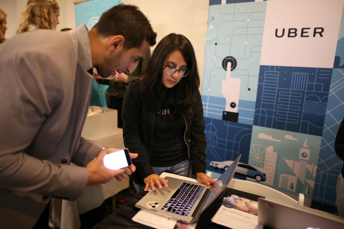FILE PHOTO: Uber recruiter Lorena Castellanos talks to one Masood Noori at TechFair LA a technology job fair in Los Angeles (REUTERS / Lucy Nicholson) 