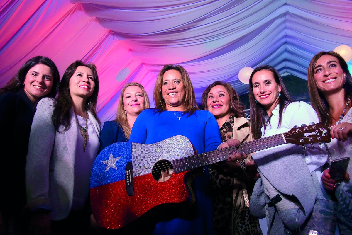 Monica Restrepo, president of the Colombia Hematology Foundation poses during a Carlos Vives guitar auction in Bogota, Colombia on March 22 2017 to support people affected by forest fires in Chile. Fire activity in Chile was worse than usual because of a 