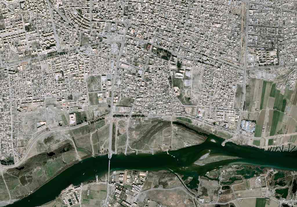 This handout image released by Airbus DS and taken by Pleiades satellites on March 11, 2017, shows a partial view of the Syrian city of Raqqa, Islamic State (IS) group's de facto capital.  AFP / Distribution Airbus DS 