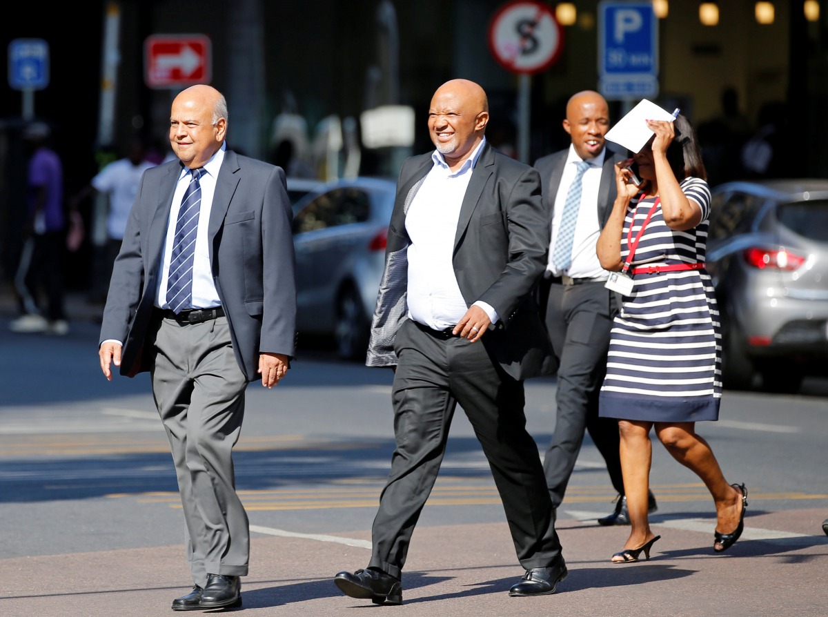 South Africa's Finance Minister Pravin Gordhan (L) walks with his deputy, Mcebisi Jonas as they walk from their offices to a court hearing in Pretoria, South Africa, March 28,2017. REUTERS/Siphiwe Sibeko