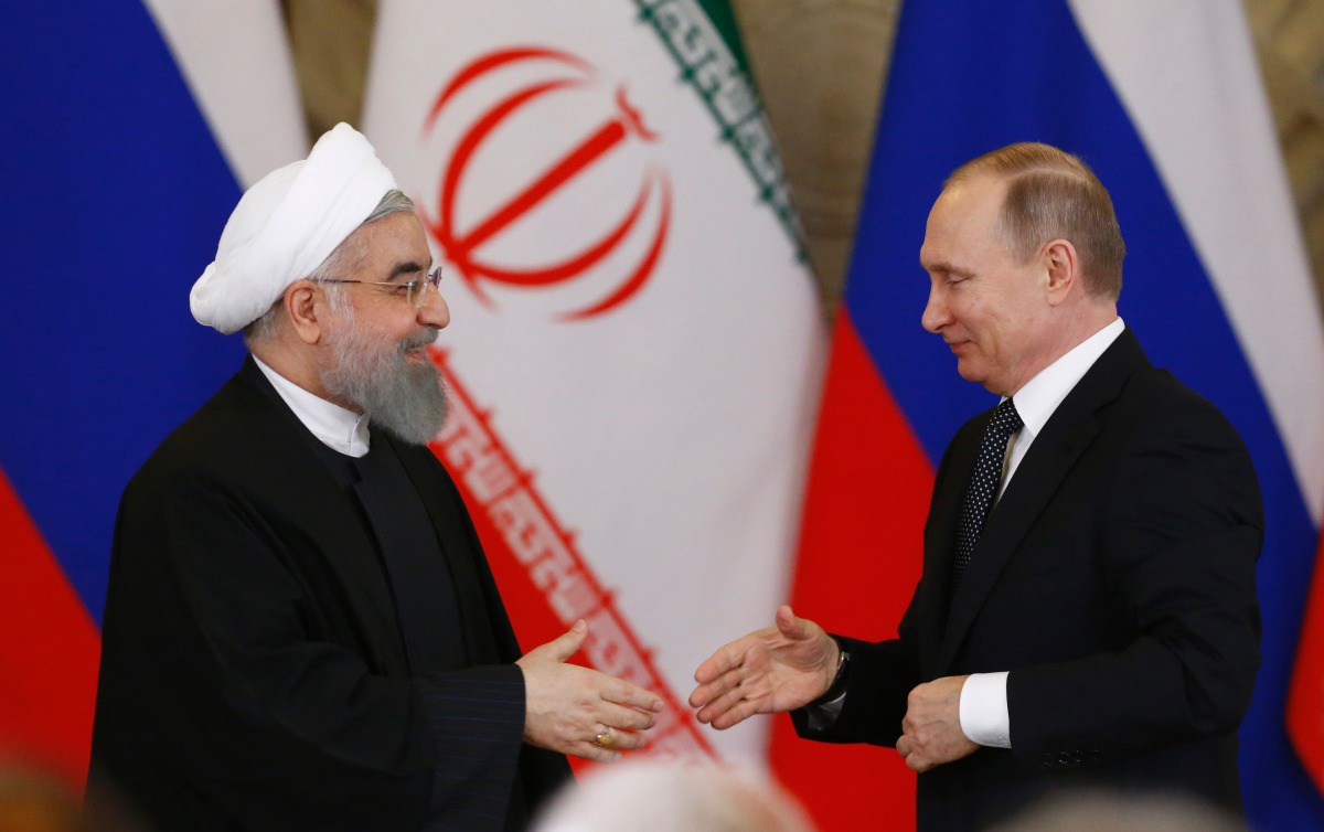 Russian President Vladimir Putin (R) shakes hands with his Iranian counterpart Hassan Rouhani during a joint press conference following their meeting at the Kremlin in Moscow on March 28, 2017.  AFP / Pool / Sergei Karpukhin