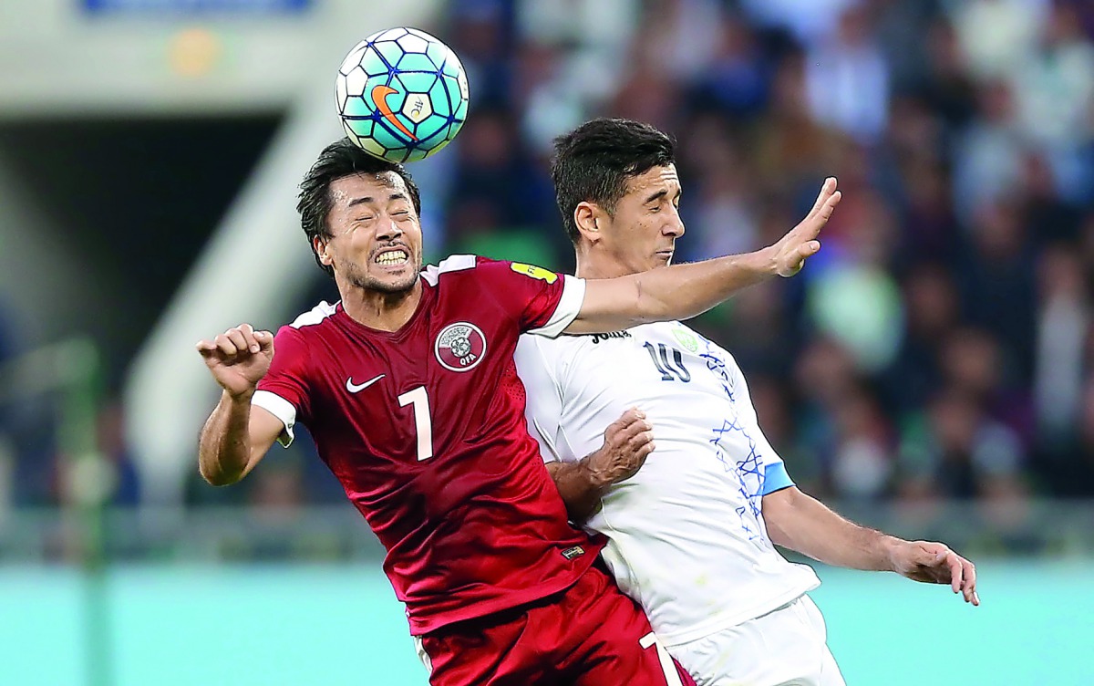 Qatari midfielder Rodrigo Tabata (left) heads the ball during the 2018 FIFA World Cup qualifying game against Uzbekistan at Bunyodkor Stadium in Uzbekistan yesterday.