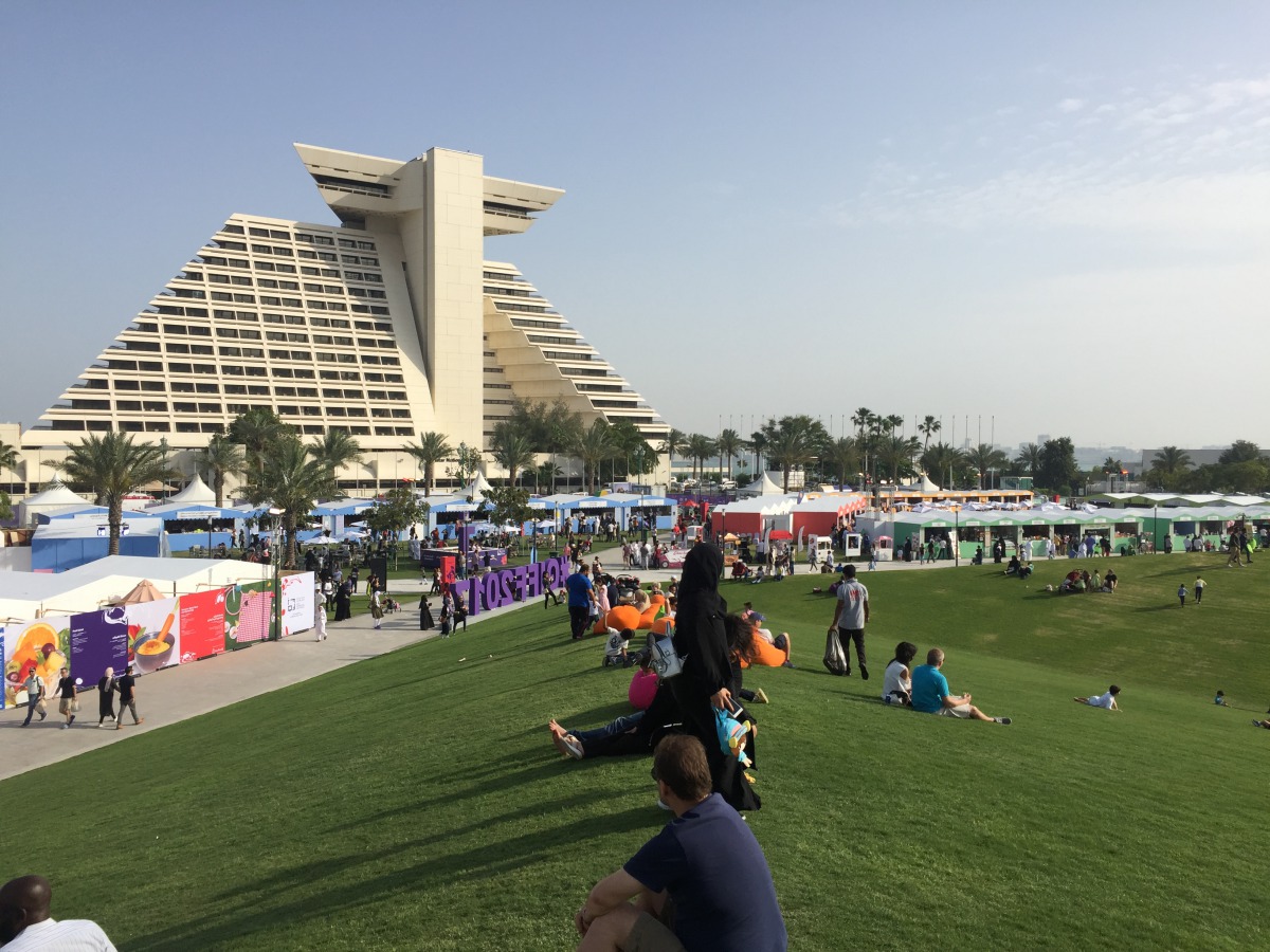 Festival visitors enjoy the vast green area of the Hotel Park yesterday afternoon.  Pic: Raynald C Rivera / The Peninsula