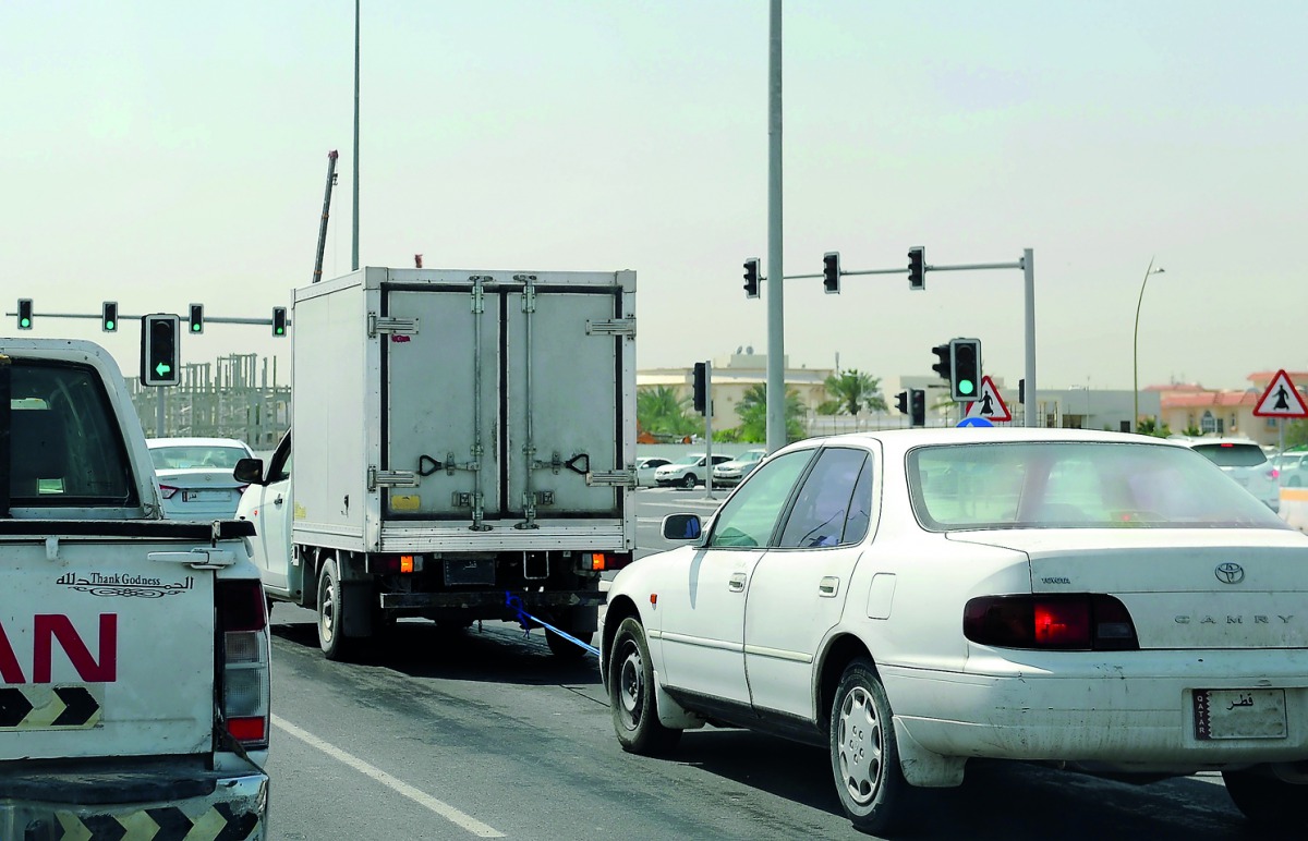 A freezer truck seen towing a car on the busy E-Ring Road.  Pic: Salim Matramkot / The Peninsula