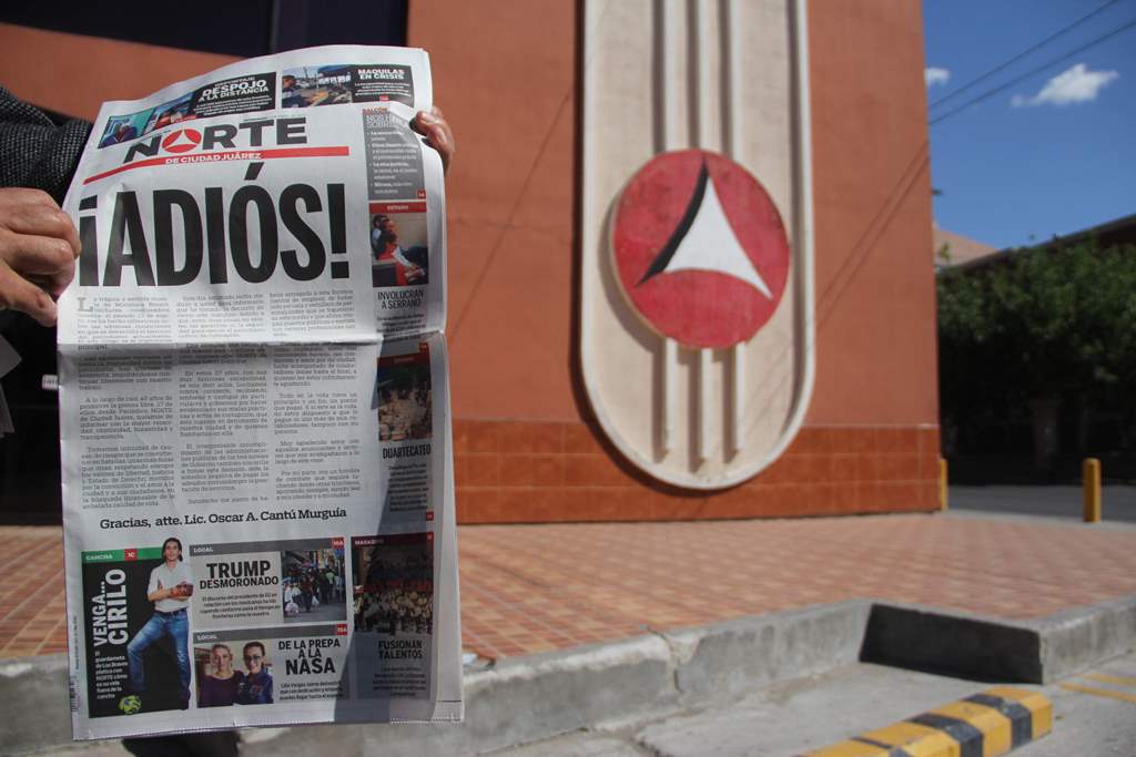 A man shows a copy of the North newspaper which announces the closing of its printed edition in Ciudad Juarez, Chihuahua, Mexico on April 2, 2017. AFP / STR