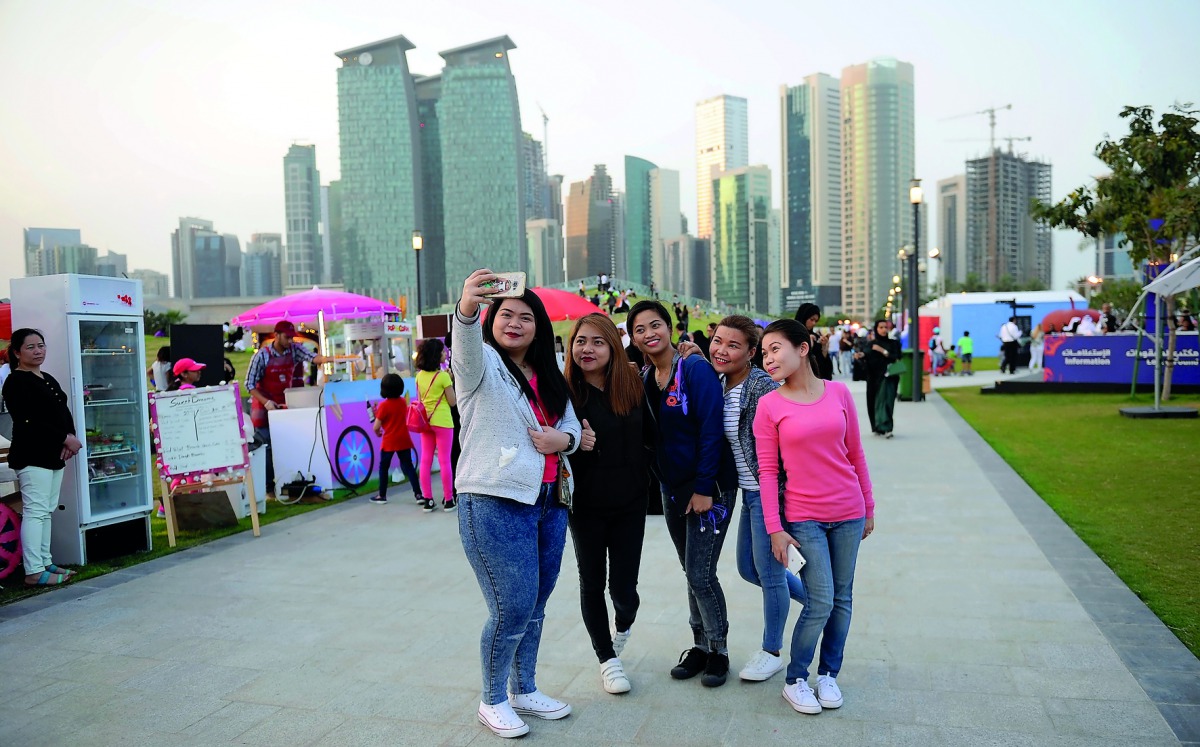 Visitors take a groufie at the Qatar International Food Festival at the Hotel Park which provides an ideal backdrop with its scenic view of the West Bay Towers and the Doha Corniche. Pic: Salim Matramkot / The Peninsula
