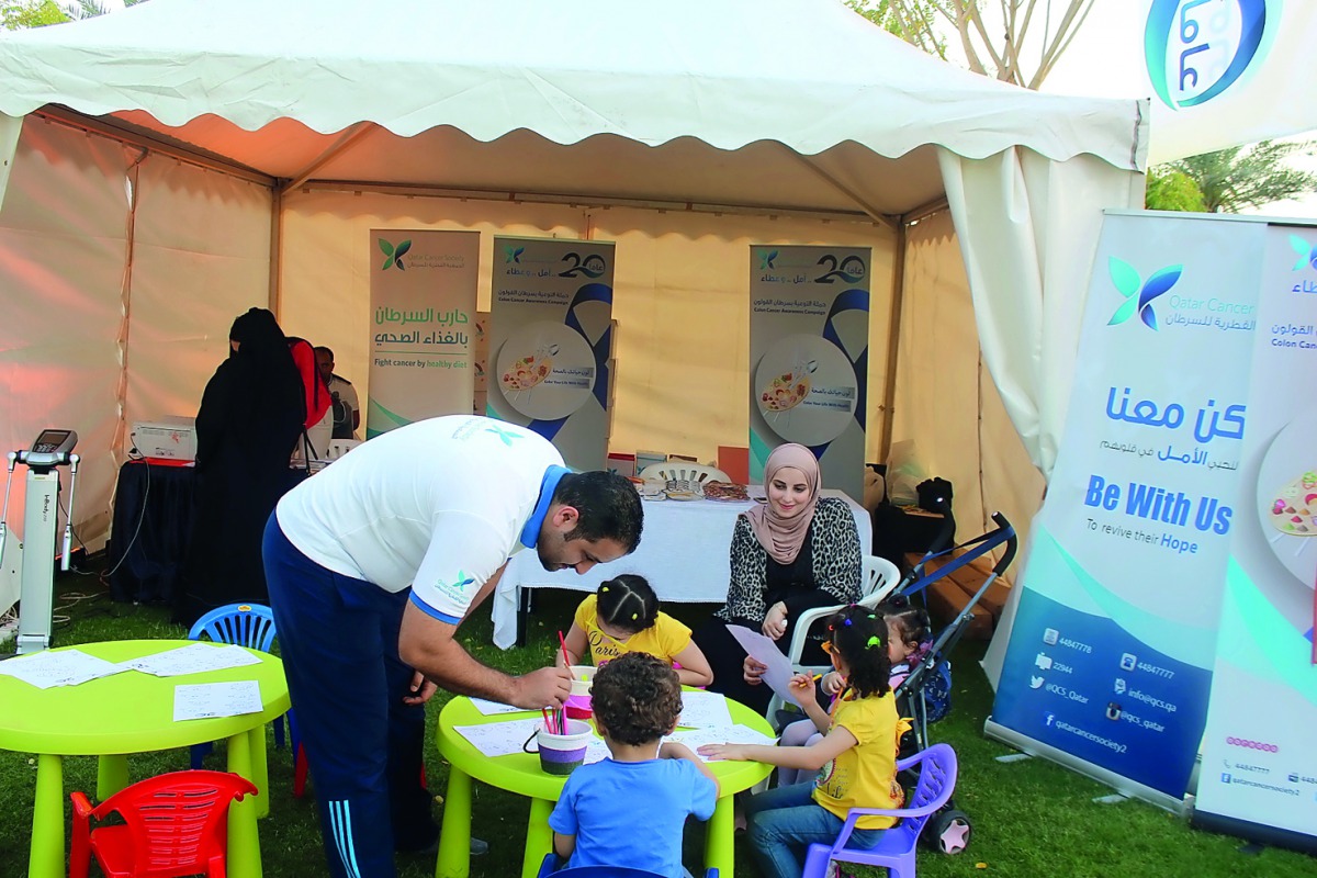QCS officials educating children about health food and exercise.