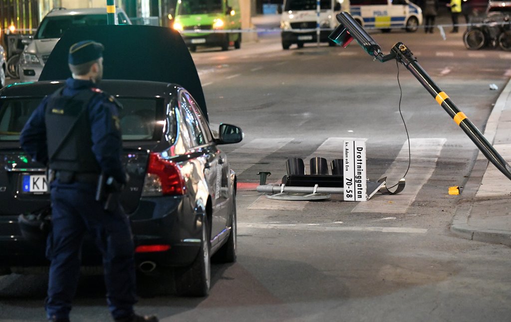 A run down traffic sign for 'Drottninggatan' is seen inside the roped off area outside the department store Ahlens after a suspected terror attack on the on the pedestrian street Drottninggatan in central Stockholm, Sweden, April 8, 2017. Maja Suslin/TT N