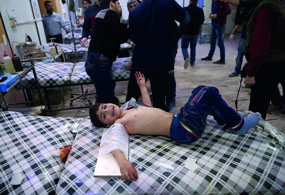 A Syrian child receives treatment at a makeshift clinic following reported air strikes by government forces in the rebel-held town of Douma, on the eastern outskirts of Damascus, yesterday.