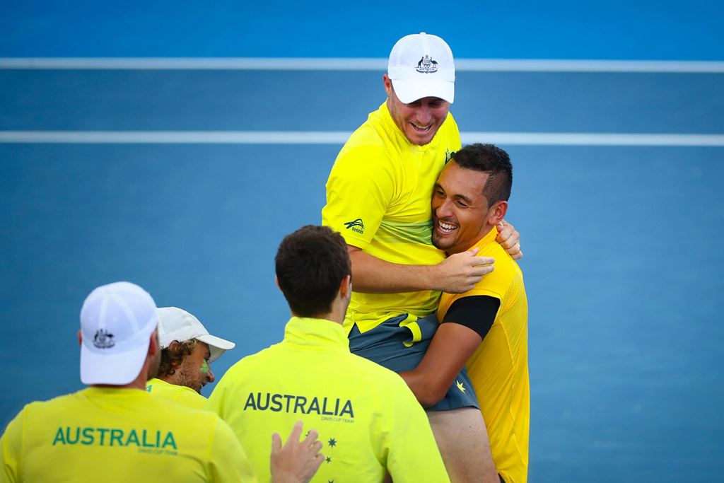 Nick Kyrgios of Australia carries team captain Lleyton Hewitt as they celebrate Australia's victory over the US after Kyrgios' match against Sam Querrey in the world group quarter-final Davis Cup clash between Australia and the USA in Brisbane on April 9,