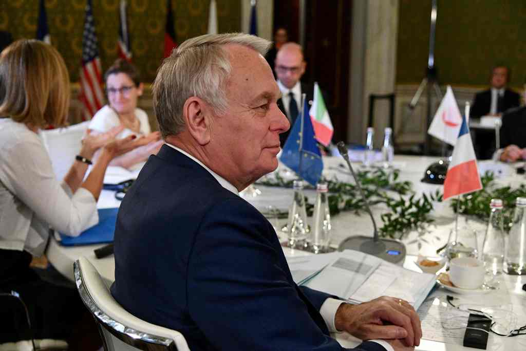 French Foreign Minister Jean-Marc Ayrault sits at a table on the second day of a meeting of Foreign Affairs Ministers from the Group of Seven (G7) industrialised countries on April 11, 2017 in Lucca, Tuscany. / AFP / Vincenzo 