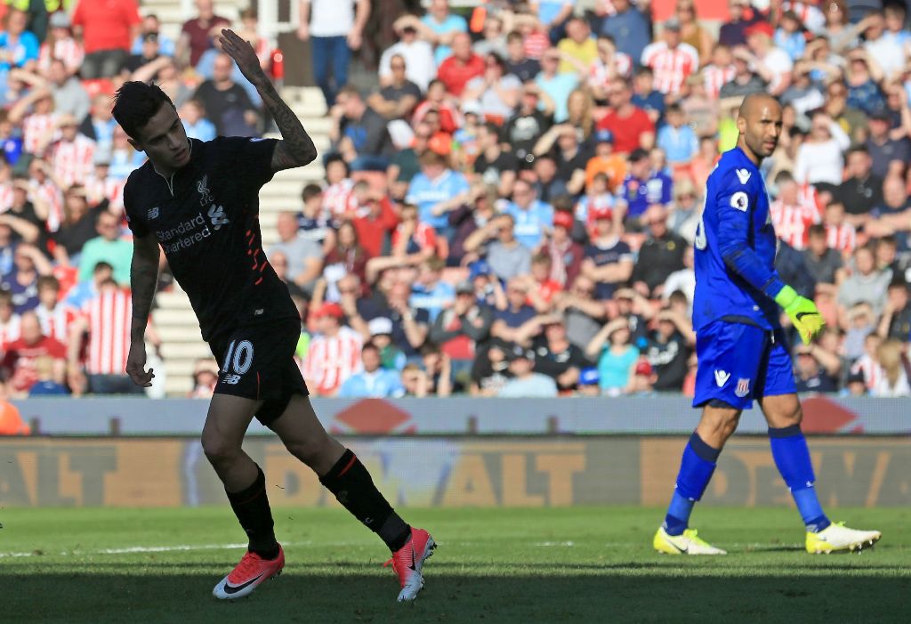 Liverpool's Brazilian midfielder Philippe Coutinho celebrates scoring his team's first goal during the English Premier League football match between Stoke City and Liverpool at the Bet365 Stadium in Stoke-on-Trent, central England on April 8, 2017.  AFP /