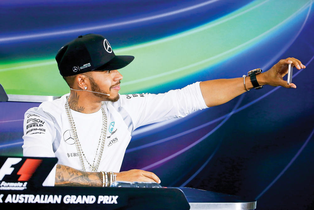 British Formula One driver Lewis Hamilton of Mercedes AMG GP takes a selfie during a press conference of the Australian Formula One Grand Prix in Melbourne, in this March 2016 file photo. 