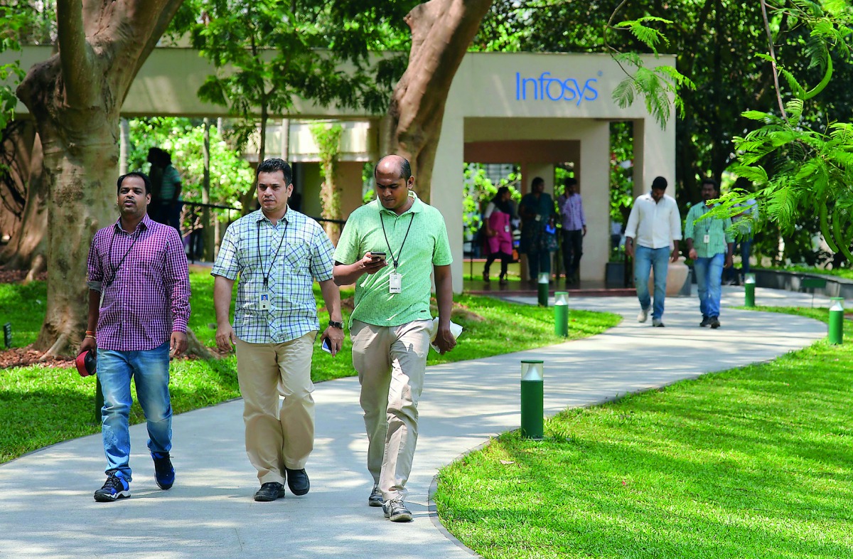 Employees of Infosys Technologies Limited walk in the campus of the company's headquarters in Bangalore on April 13, 2017. Indian software giant Infosys has pledged to return USD2 billion to shareholders this year as it reported subdued growth in profits 