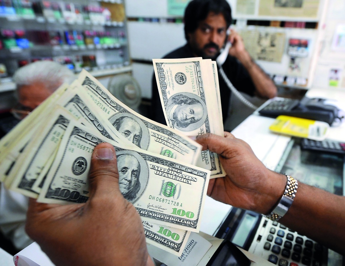 A dealer counting US dollar notes at a money changer in Singapore. 