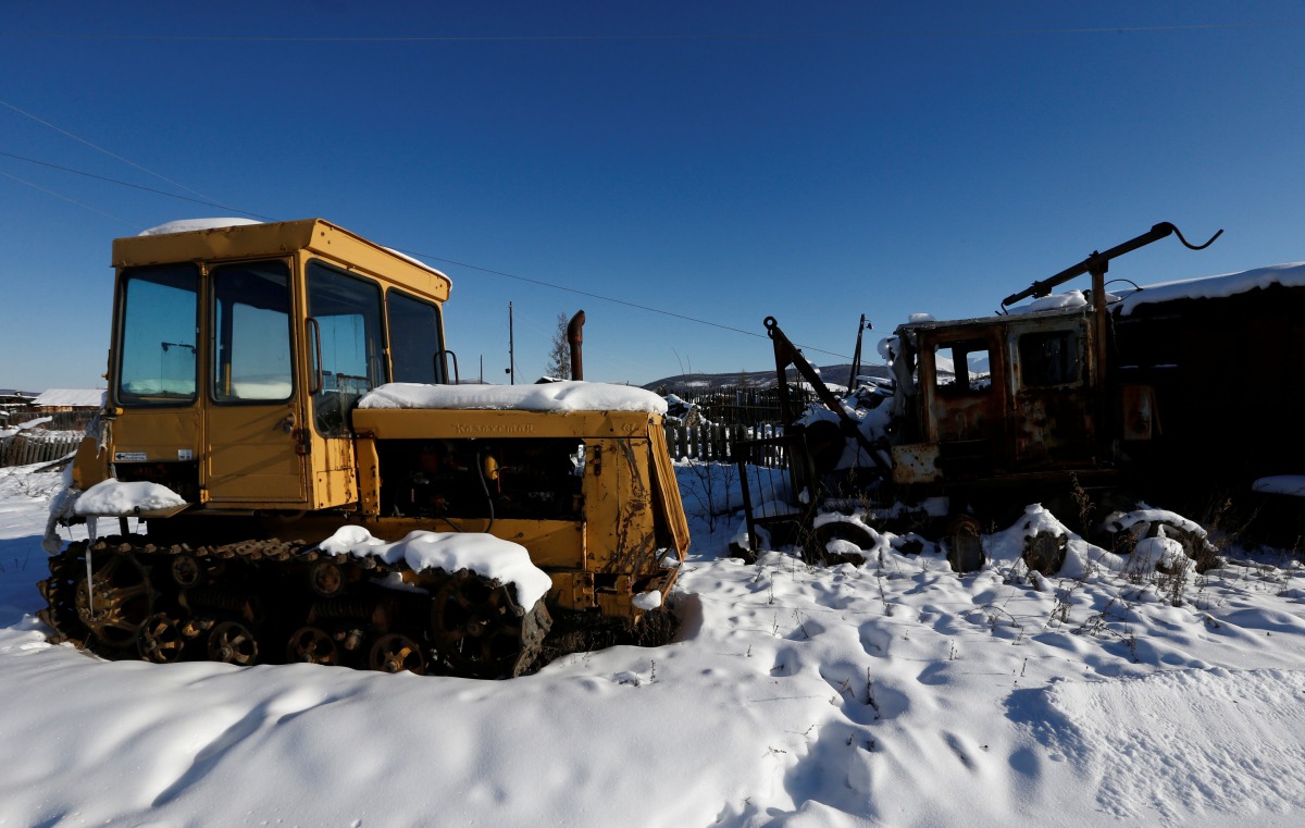 Abandoned tractors are seen at a decommissioned placer mine in the settlement of Nelkan, Republic of Sakha (Yakutia), Russia, March 22, 2017. REUTERS/Sergei Karpukhin