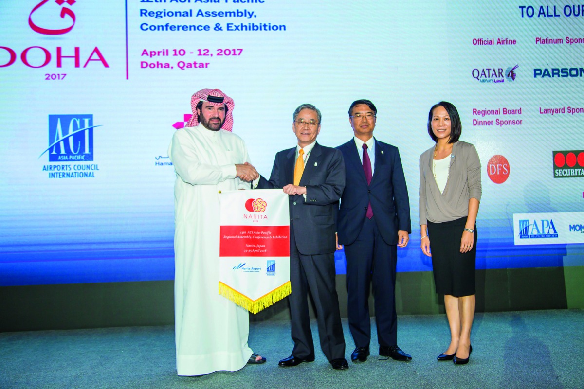 Abdulaziz Al Mass, Vice-President Commercial and Marketing of HIA (left) handing over the flag to Kenichi Fukaya, Senior Executive Adviser of Narita International Airport in the presence of Futoshi Osada, Executive Vice-President of Narita International A
