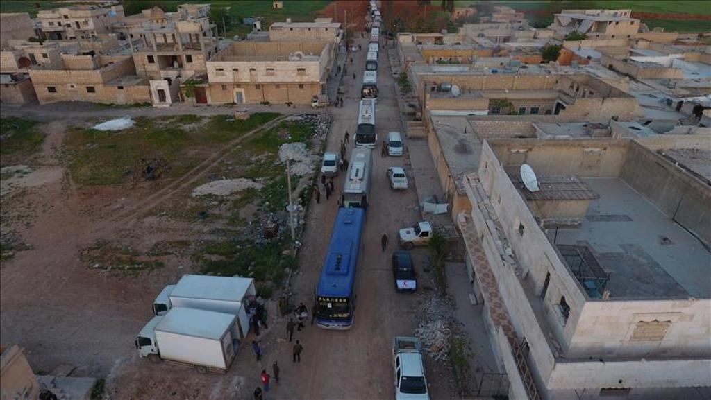 Buses carry Syrian civilians and opponent forces members, evacuated from Al-Waer district of Homs, Syria on April 19, 2017. ( Jawad Al Rifai - Anadolu Agency ).