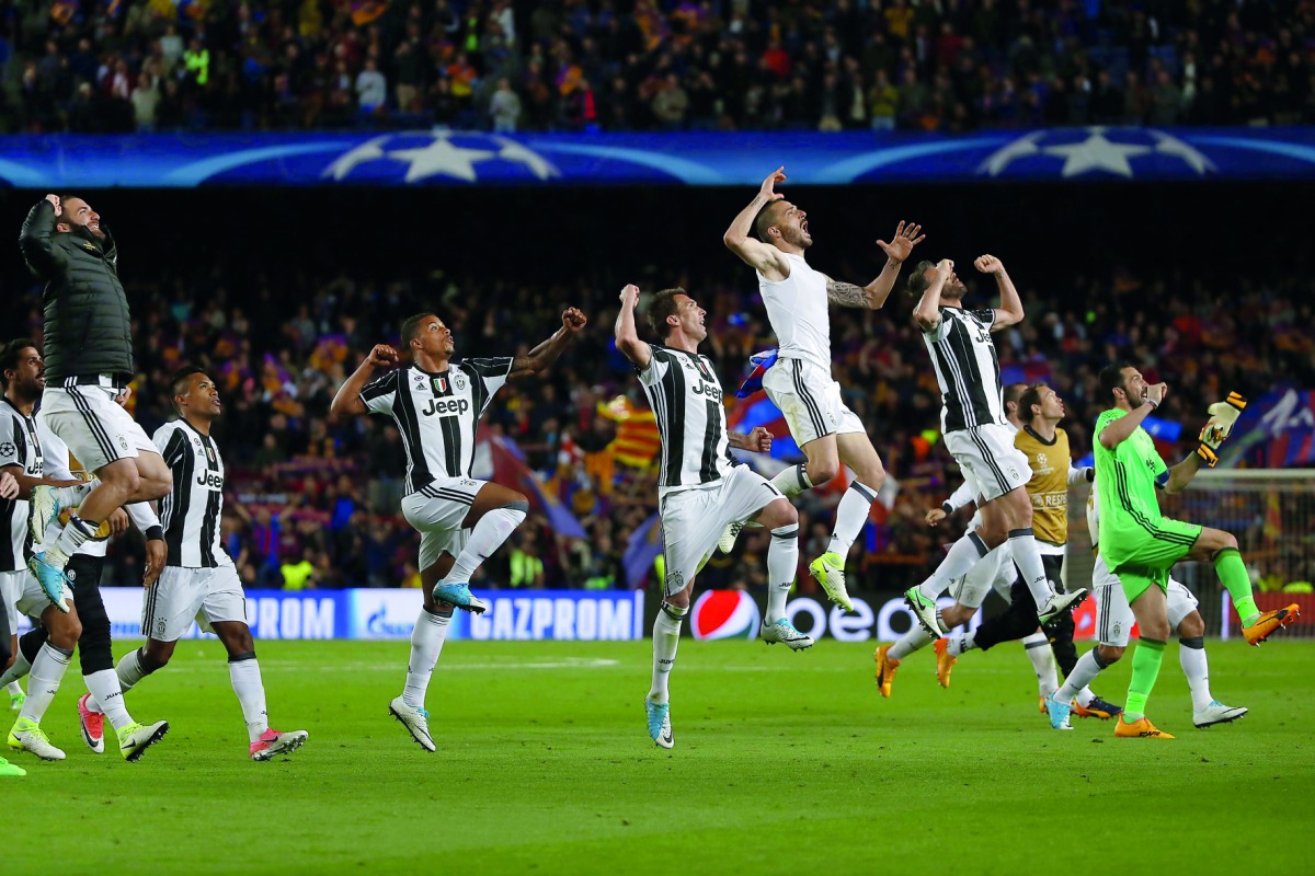 Juventus players celebrate after winning the UEFA Champions League quarter-final second leg football match against FC Barcelona at the Camp Nou Stadium in Barcelona.