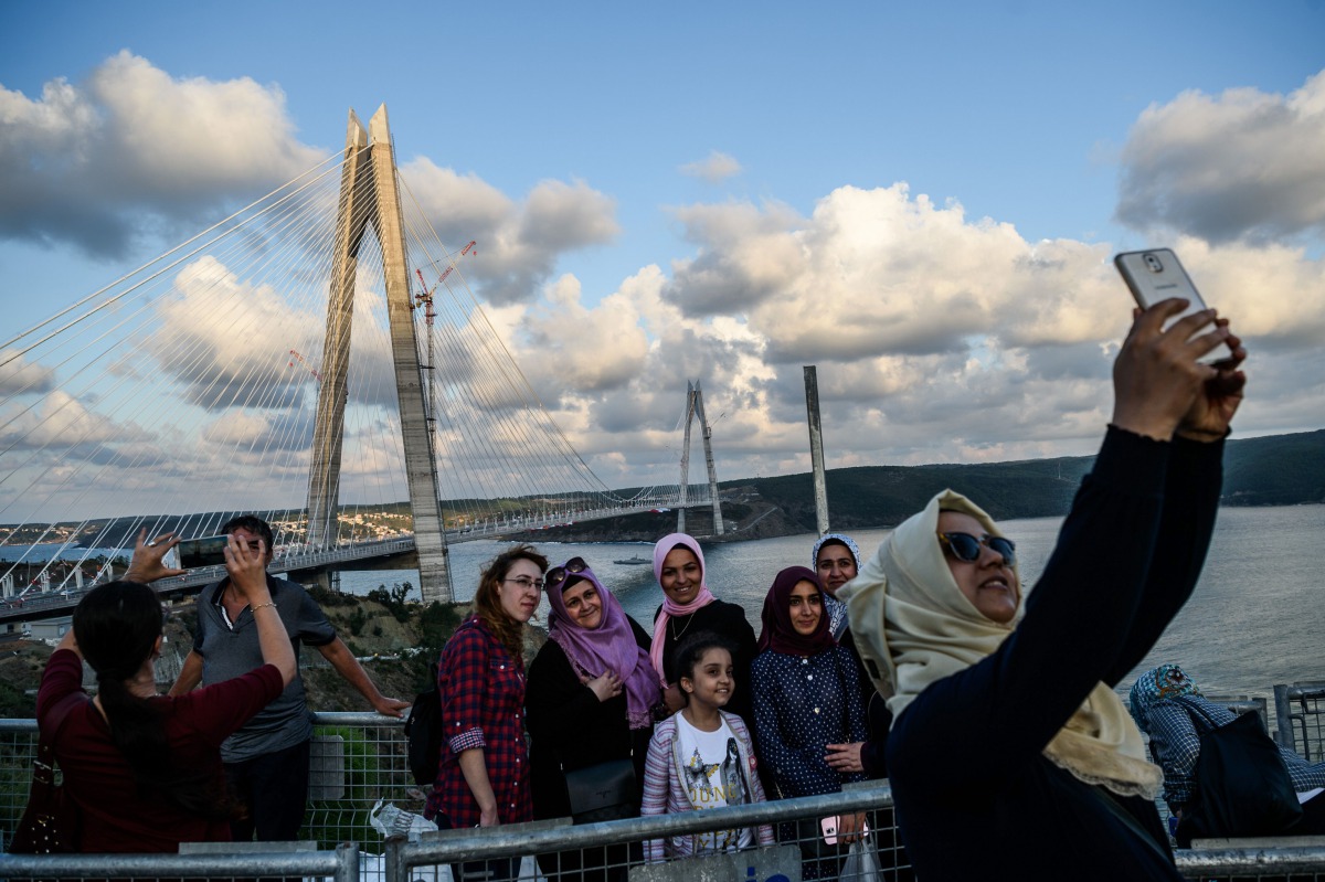 REPRESENTATIVE IMAGE: People take selfies as they pose next to the Yavuz Sultan Selim bridge on August 26, 2016 in Istanbul during the inauguration of the bridge (AFP) 