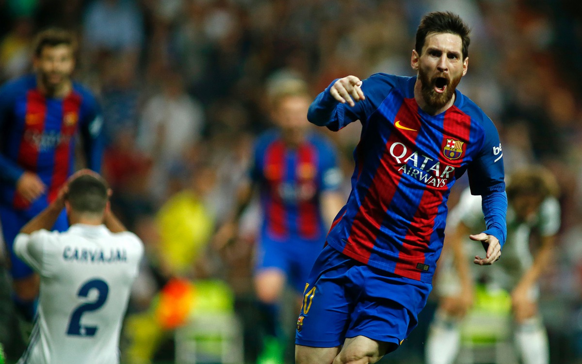 Barcelona's Argentinian forward Lionel Messi celebrates Barcelona's third goal during the Spanish league football match Real Madrid CF vs FC Barcelona at the Santiago Bernabeu stadium in Madrid on April 23, 2017.