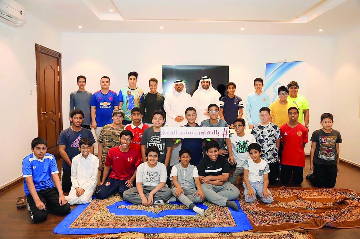 Officials and children at the awareness lecture. 