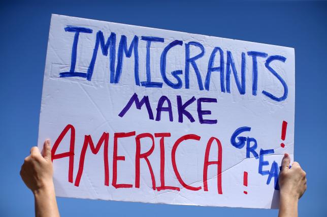 Immigrant-rights advocates protest near the US-Mexico border wall over a visit to the border by US Attorney General Jeff Sessions and Secretary of Homeland Security John Kelly in San Ysidro, a district of San Diego, California, US, April 21, 2017. Reuters